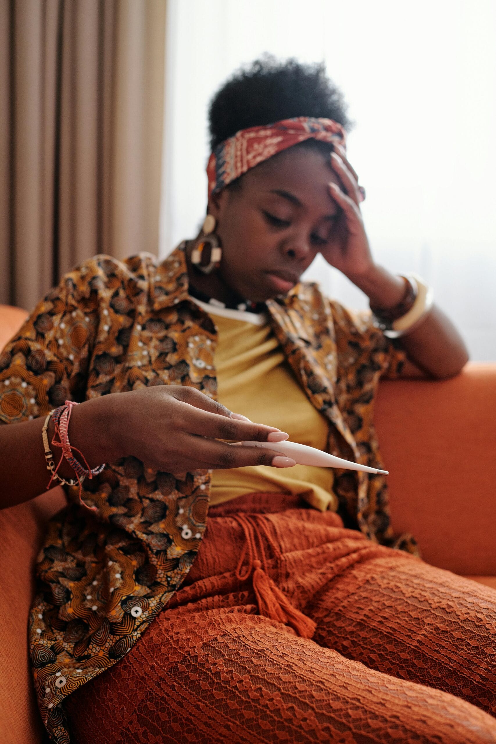 A woman looking at the results of a thermometer